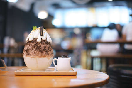 Bingsu or Asian Ice flake dessert with chocolate and sweet milk whip cream on topの写真素材