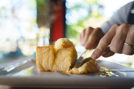 Eating sweet bread or honey toast with ice creamの写真素材