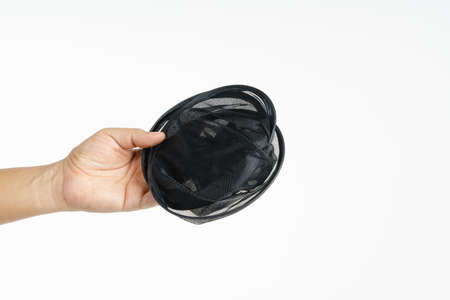 Hand holding folding sunshade retractable for windows or car windshield on white background