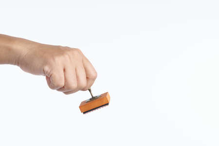 Hand holding vintage hand stamper for stamp on white background