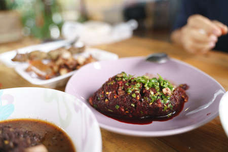 Eating raw spicy minced meat salad, a popular traditional Thai food for local peopleの写真素材