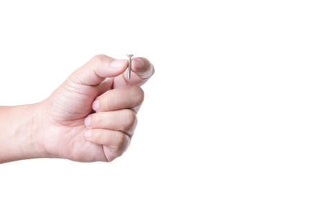 Hand holding steel screw, bolt for fastening metal like computer or electronic deviceの写真素材