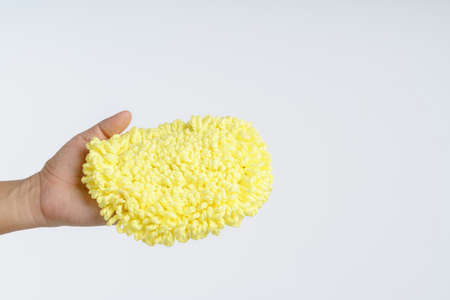 Hand holding dust glove mitt microfiber car wash on white backgroundの写真素材