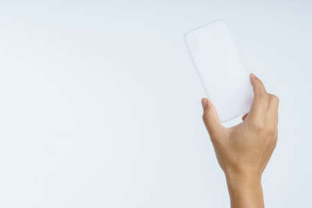 Hand holding modern silicone or rubber phone case on white backgroundの写真素材