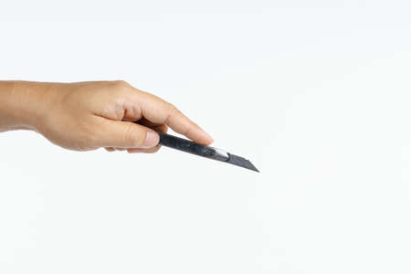 Hand holding stainless office  paper cutter on white background