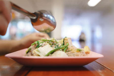 Eating Thai dry sukiyaki or stir fried noodle with vegetableの写真素材