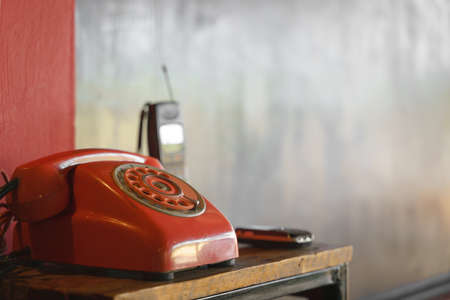 Old rotary dial landline or corded phone with vintage mobile cellphone