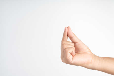 Hand picking up something like a paper on white backgroundの写真素材