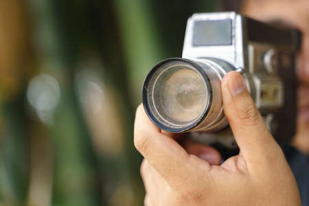 Hand holding old 8mm film video handheld recorder with defective lens