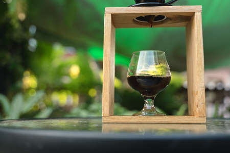 Coffee drip process by pouring hot water though ground berries bean with filter