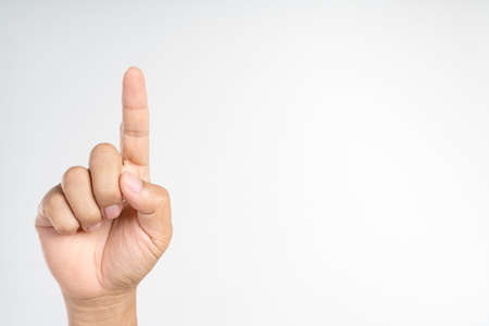 Hand pointing or doing number one gesture with index finger on white backgroundの写真素材
