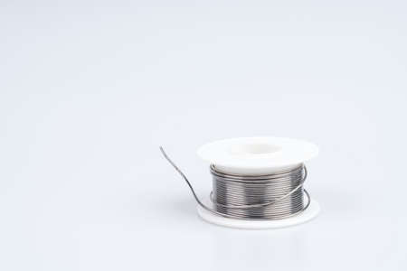 Solder wire roll for soldering in electronic equipment on white background