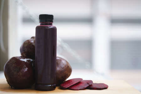 Cold pressed pure beetroot vegetable juice from slow juicer in plastic bottleの写真素材