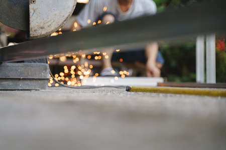 Blurred worker labor welding wire metal with fire spark for building and reinforcement