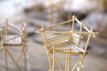 A small construction made from wood stick, glue and threadの写真素材