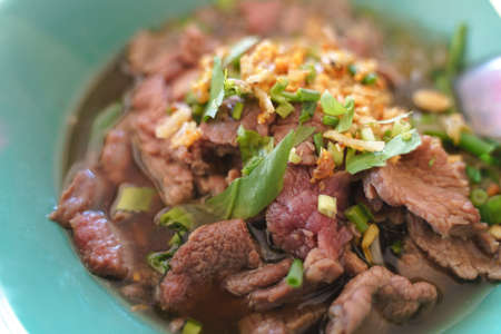 Thai traditional noodles with roughly boil red blood meat and vegetablesの写真素材