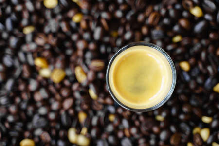 Small shot cup of espresso coffee with roasted bean as backgroundの写真素材