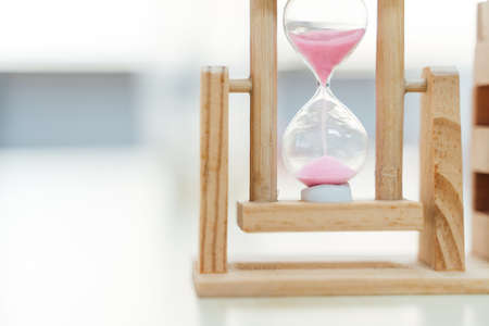 Small minute sand hourglass timer with wooden standの写真素材