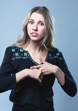 Closeup portrait of a girl, on an isolated gray background. Human face expression, emotions, feeling attitude reactionの写真素材