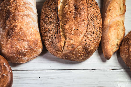 Various rustic bread on a wooden board. Healthy food and farming concept