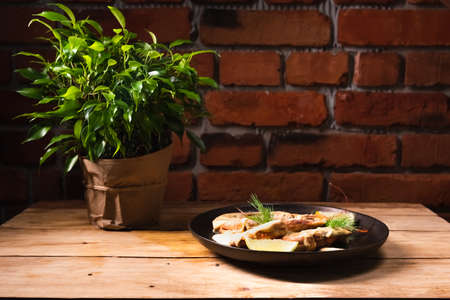 Delicious fried langoustines in sauce on a black plate, prepared in an Asian style. Fast and ready meal conceptの写真素材