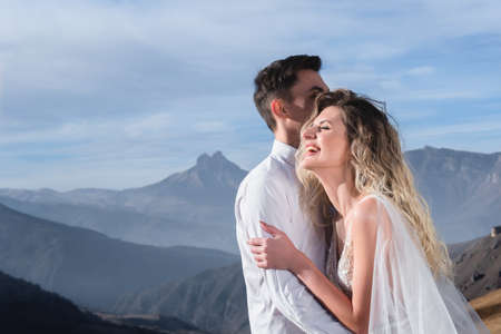 A newlywed couple on the background of beautiful autumn mountains. The concept of holding a wedding...
