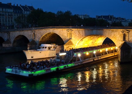 Boats on the night Seine in Parisの写真素材