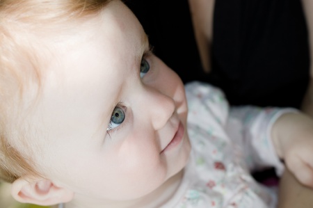 Little baby fondly looking to motherの写真素材