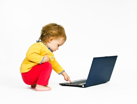 Cute little girl with blue laptop isolated on white background