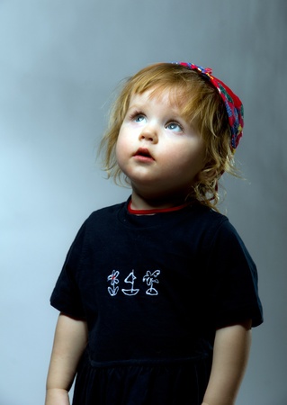Cute little girl in red hat and dark dressの写真素材