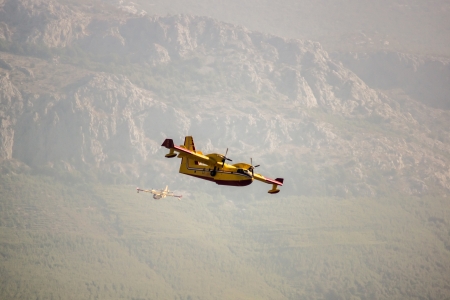 Fire fighter plane over the mountains. Croatia.