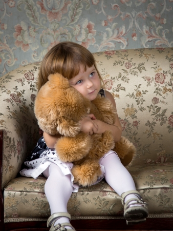 Cute little girl portrait in studio with teddy-bearの写真素材