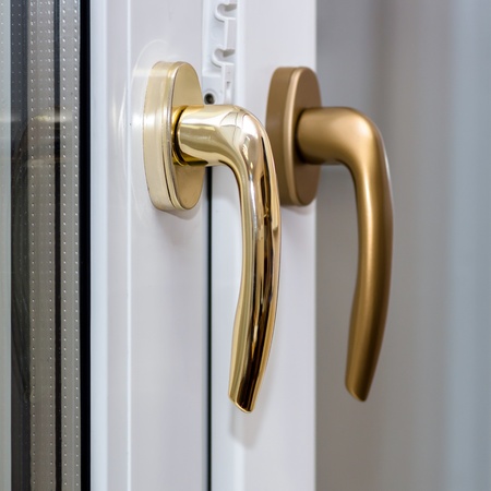 Window handles on plastic window. Gold color. PVC.の写真素材