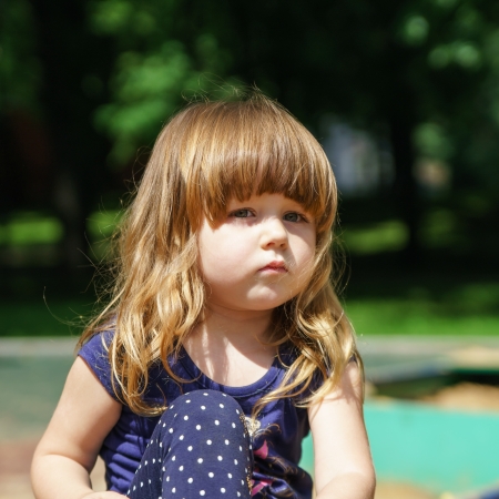 Cute little girl playing on child playgroundの写真素材