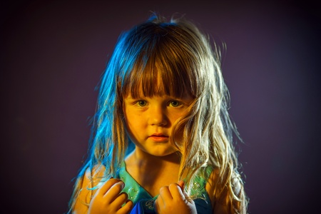 Cute little girl portrait in blue and orange colorsの写真素材