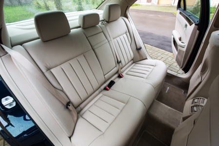 Ivory color luxury town car passengers interior.