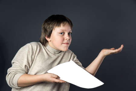 Teenage boy emotion portrait. Isolated on grey background.の写真素材