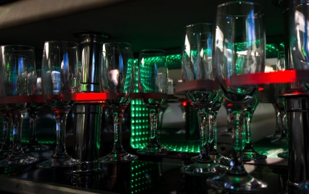 Empty wine glasses in luxury party limousine interiorの写真素材