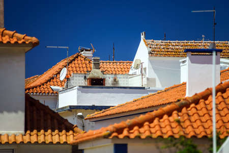 Contrast and colorful tile roofs view. Ericeira, Portugal.の写真素材