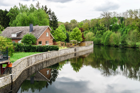 Small village lanscape with calm river, Han-sur-Lesse, Belgiumのeditorial素材