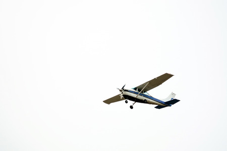 Small airplane in the sky isolated on white background