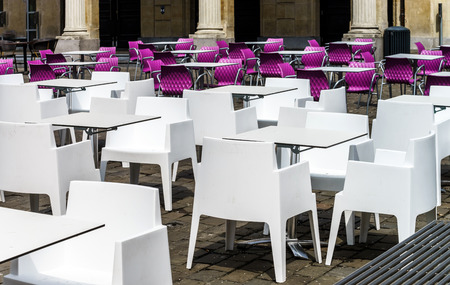 White and violet chairs and tables in street cafeの写真素材