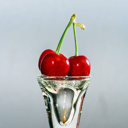 CJuicy black cherry isolated on grey background,summer berryの写真素材