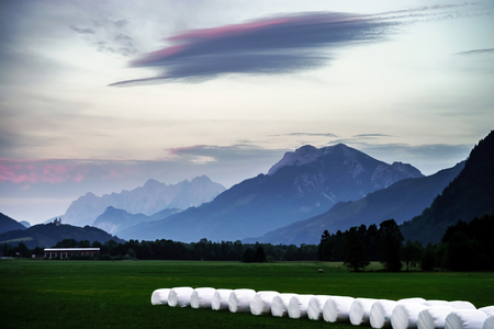 Sunset landscape in austrian Alps, fields and mountainsの写真素材