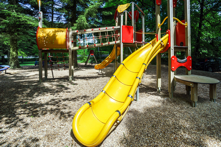 Public children playground in summer park, Belgium