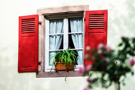 Renovated windows with shutters in village timber-frame houseの写真素材