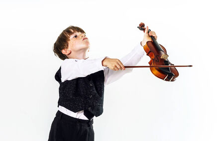 Red-haired preschooler boy with violin, music education