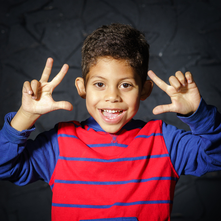 Emotional little black afro-american boy posing in studioの写真素材