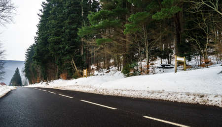 New asphalt auto road in Alsace mountains, France, winterの写真素材