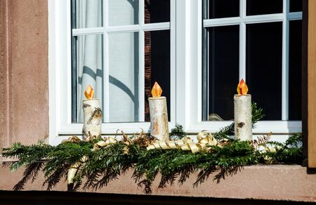 Homemade christmas candles making from birch wood, countryhouse window decoration